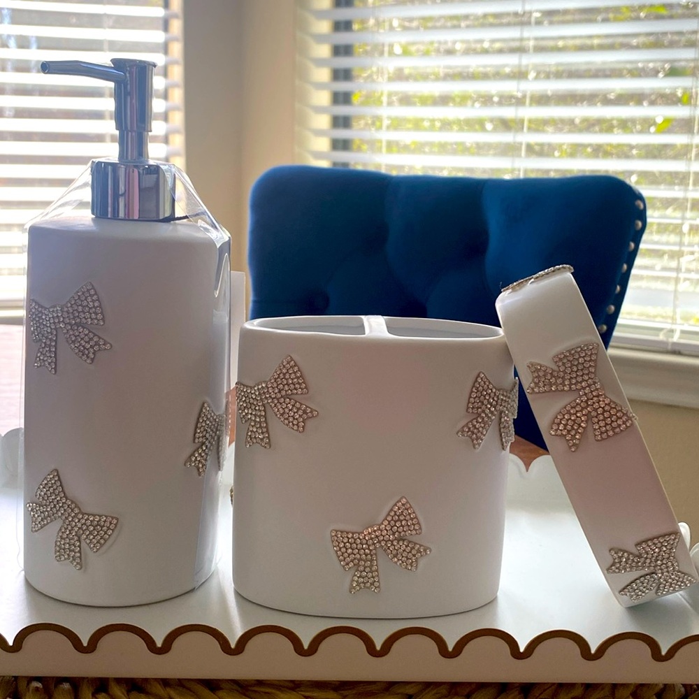 Bathroom rhinestone bows soap dispenser, toothbrush holder and bar soap holder.